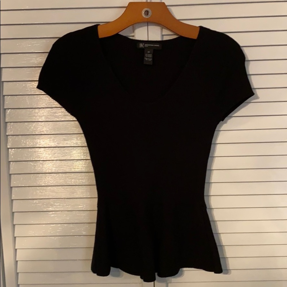 V-neck sweater, flared out at waistline.
